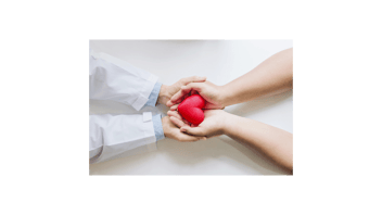 Two sets of hands holding a red heart shape together.