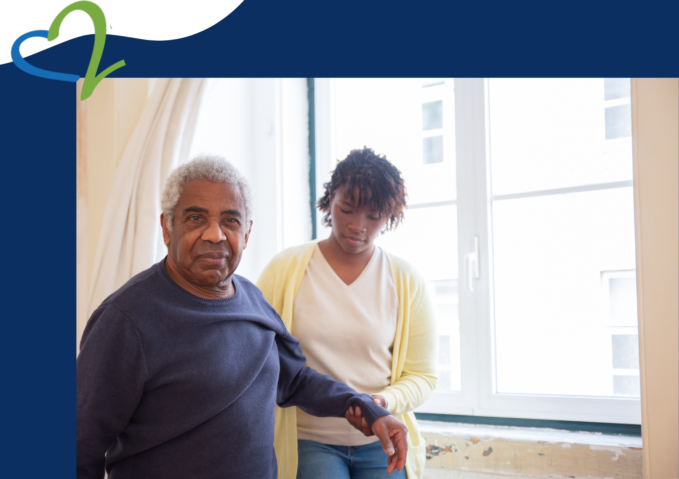 A Black male patient being supported by a caregiver