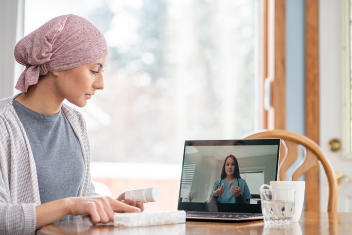 Female cancer patient in telemedicine appointment with oncologist.